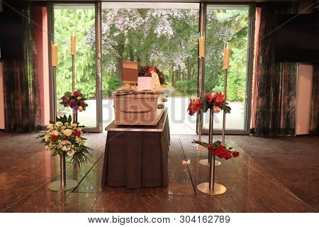 A Coffin With A Flower Arrangement In A Morgue, A Funeral Service