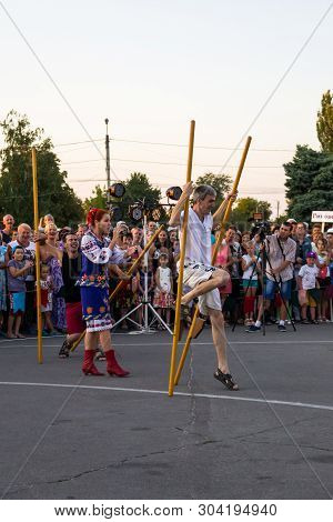 Men Compete In Walking On Wooden Stilts