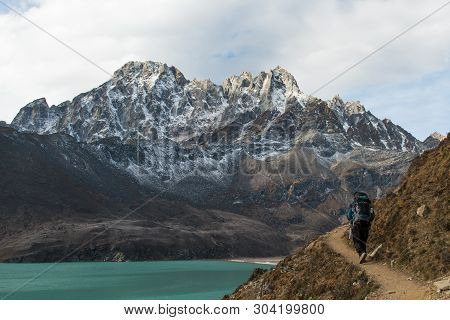 Trekker On The Way To Renjola Pass With Beautiful Green Water In Glacier On The Way To Gokyo Village