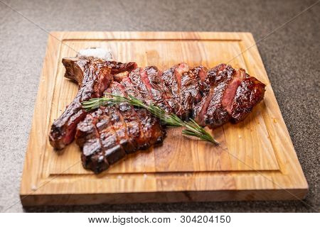 Food And Horse Meat Concept - Roast Meat On Cutting Board With Cumin