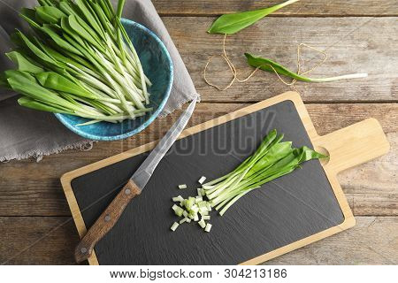 Flat Lay Composition With Wild Garlic Or Ramson On Wooden Table