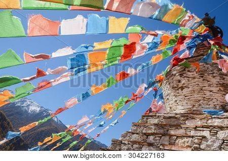 Colorful Tibetan Flags And Snow Mountain At Siguniang Scenic Area In Autumn Season,chengdu, China.