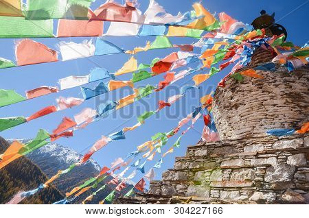 Colorful Tibetan Flags And Snow Mountain At Siguniang Scenic Area In Autumn Season,chengdu, China.