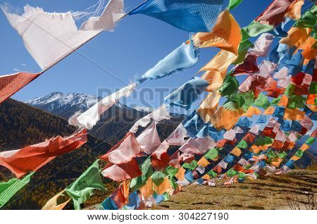 Colorful Tibetan Flags And Snow Mountain At Siguniang Scenic Area In Autumn Season,chengdu, China.