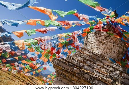 Colorful Tibetan Flags And Snow Mountain At Siguniang Scenic Area In Autumn Season,chengdu, China.