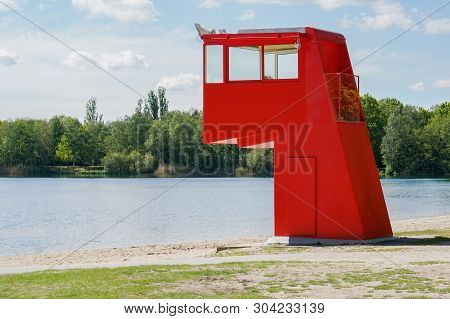 Vibrant Red Lifeguard Station Or Tower At Swimming Lake In Germany