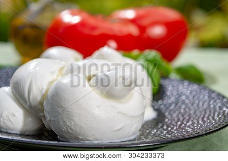 Twisted To Form A Plait Treccia Mozzarella Italian Soft Cheese Served With Fresh Basil And Tomatoes