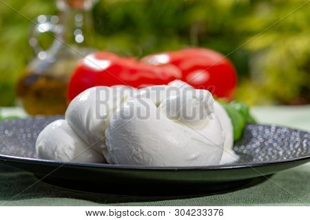 Twisted To Form A Plait Treccia Mozzarella Italian Soft Cheese Served With Fresh Basil And Tomatoes