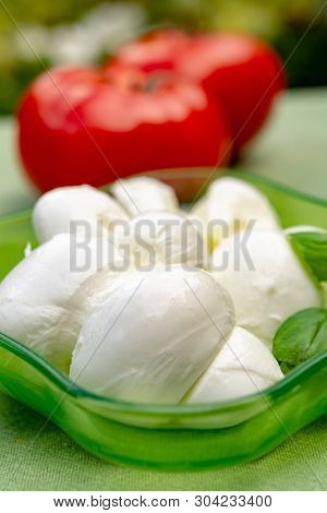 Twisted To Form A Plait Treccia Mozzarella Italian Soft Cheese Served With Fresh Basil And Tomatoes