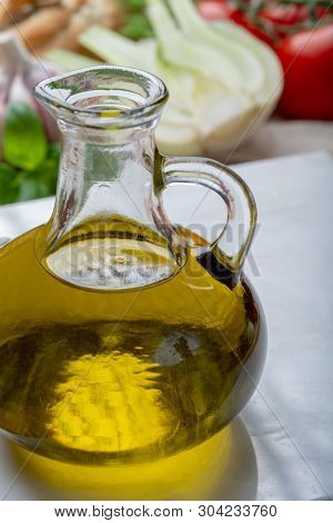 Virgin Natural Olive Oil Is Glass Bottle, Served With Traditional Mediterranean Food