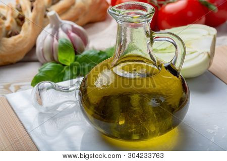Virgin Natural Olive Oil Is Glass Bottle, Served With Traditional Mediterranean Food