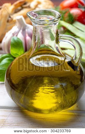 Virgin Natural Olive Oil Is Glass Bottle, Served With Traditional Mediterranean Food