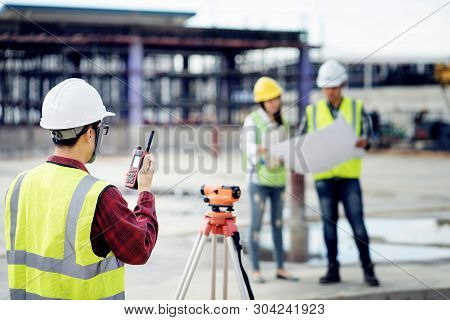 Foreman 3 People Are Sitting To See A Blueprint About The Factory Building Structure On The Job Site