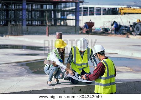 Foreman 3 People Are Sitting To See A Blueprint About The Factory Building Structure On The Job Site
