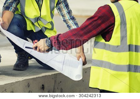 Foreman 3 People Are  See A Blueprint About The Factory Building Structure On The Job Site.foreman, 