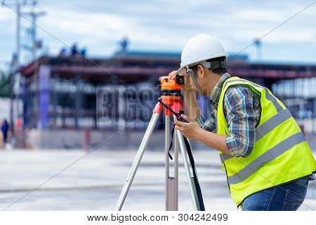 surveyor engineer with theodolite at construction site during surveying work.engineer and architect 