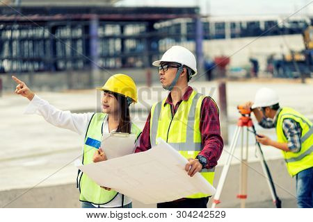 Surveyor Engineer With Theodolite At Construction Site During Surveying Work.engineer And Architect 