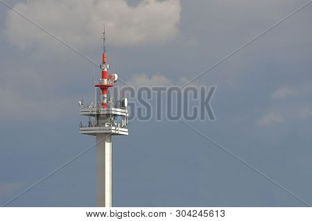 Radio Tower With Antennas On A Blue Sky Background. Metal Construction. Wireless Network. Transmit T