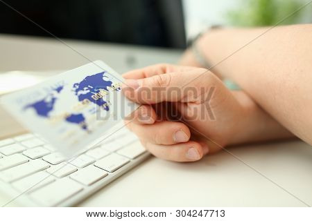 Male Hand Businessman Hold White Plastic Card Aganist Keyboard Background. Fast Maney Concept.