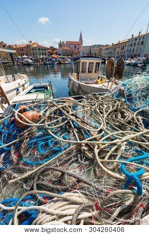 Scenic Harbour With Boats And Brightly Coloured Houses On The Fishing Net Waterfront In Izola - Isol