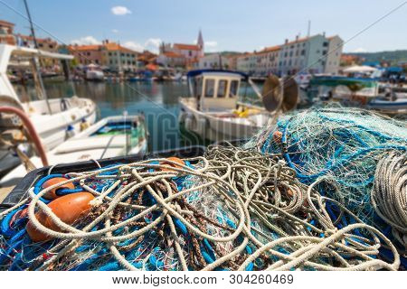 Scenic Harbour With Boats And Brightly Coloured Houses On The Fishing Net Waterfront In Izola - Isol