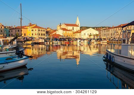 Izola, Slovenia - May 1, 2019: Scenic Harbour With Boats And Brightly Coloured Houses On The Sunset 