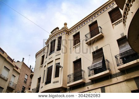 Old Colorful And Majestic Tiled Facades With Vintage Streetlight In Elche, Alicante, Spain. El Raval