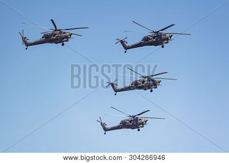 Moscow, Russia - May 07, 2019: Group Of Attack Helicopters Mi-28n In The Blue Sky Over Red Square. A