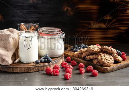 Raspberries In Foreground, Milk And Cookies In Backround