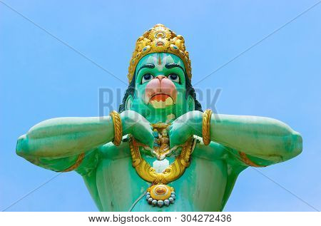 Green Statue Hindu God Of Lord Hanuman, Known As The Lord Of Celibacy,on A Background Of Clear Blue 