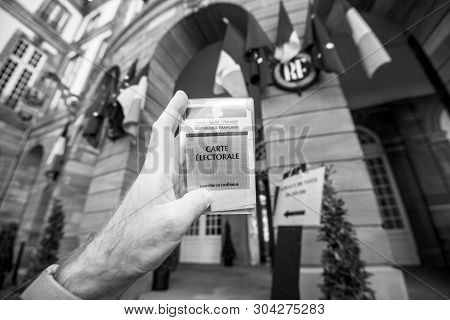Strasbourg, France - May 26, 2019: Image Of Man Hand Holding Voters Car French Carte Electorale With