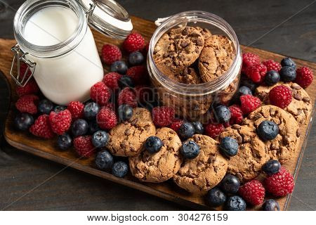 Lots Of Forest Fruits And Biscuits On Wooden Board, Closeup Shot.