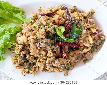 Spicy Minced Pork Salad On White Plate With Herb And Fresh Vegetable Dried Chilli And Lettuce- Thai 