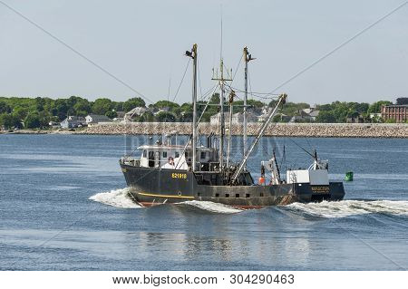 New Bedford, Massachusetts, Usa - May 31, 2019: Commercial Fishing Vessel Reflection Heading Out On 
