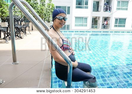Pregnant Women Exercise Swimming In Pool