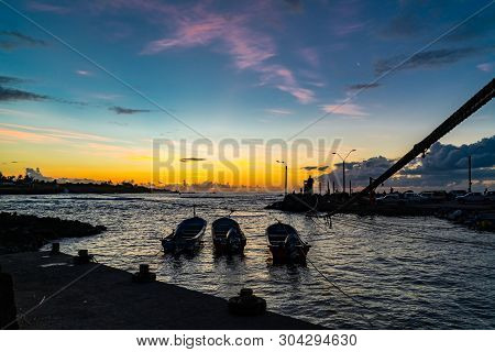 Silhouette Of Fisherman Port Of Hanga Roa Village At Sunset In Easter Island, Chile