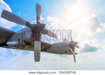 Two Engine Aircraft Propeller Of Turboprop Airplane Flying High In Cloudy Sky With Sun Shine Brightl