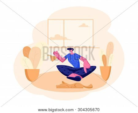Smiling Man Sitting On Floor With Tea Pot In Hands At Home Domestic Interior. Male Character Having 