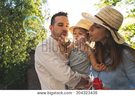 Happy Hispanic Family Having Fun Together Outdoors.