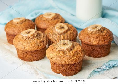 Banana Muffin, Side View, Close Up. Cupcakes On Blue Napkin With Milk In A Bittle, White Concrete Ta