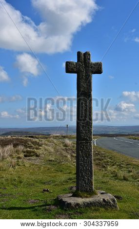Stone Cross Waymarker On Moorland In North Yorkshire England.