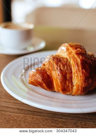 White Opened Notebook With Cup Of Cappuccino And Tasty Croissant On The Wooden Desktop. Flat Lay Sty