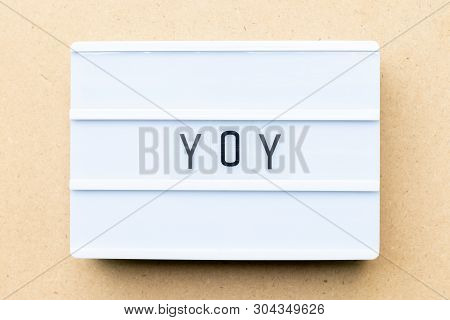 White Lightbox With Word Yoy (abbreviation Of Year Over Year) On Wood Background