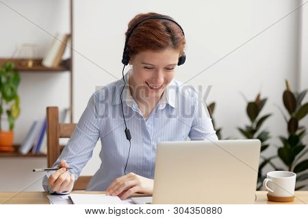 Happy Smiling Businesswoman In Headphones Self-study At Office Desk