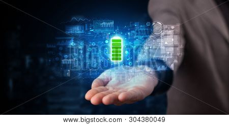 Elegant hand holding battery with full of energy