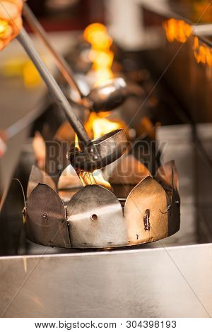 People Fill Oil On Lantern In Wat Rakhang Khositaram Bangkok ,thailand