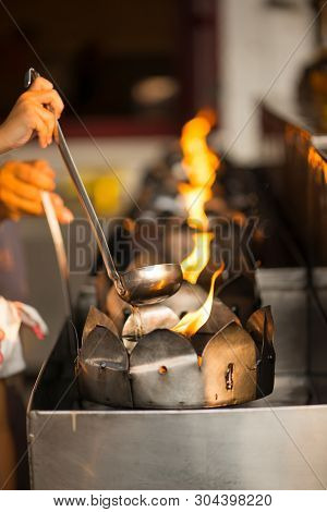 People Fill Oil On Lantern In Wat Rakhang Khositaram Bangkok ,thailand