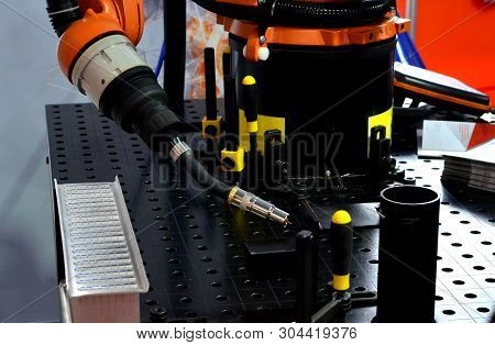Welding Robotic Arm At Industrial Manufacture Factory. Shooting In Real Conditions, A Slight Blur Of