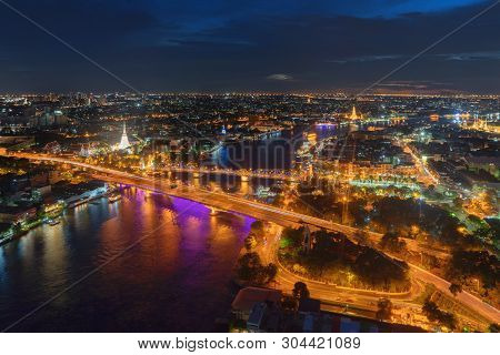 White Prayoon Pagoda, Memorial Bridge, And Phra Pok Klao Bridge With Buildings And Curve Of Chao Phr