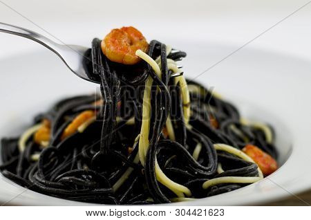 Italian Black Spaghetti, Alla Veneziana, With Grilled Prawns And Dried Tomatoes. With Olive Oil, Gar